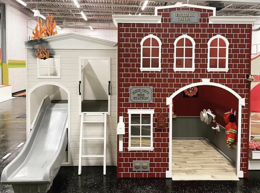 A fire station with a slide and a slide ramp.