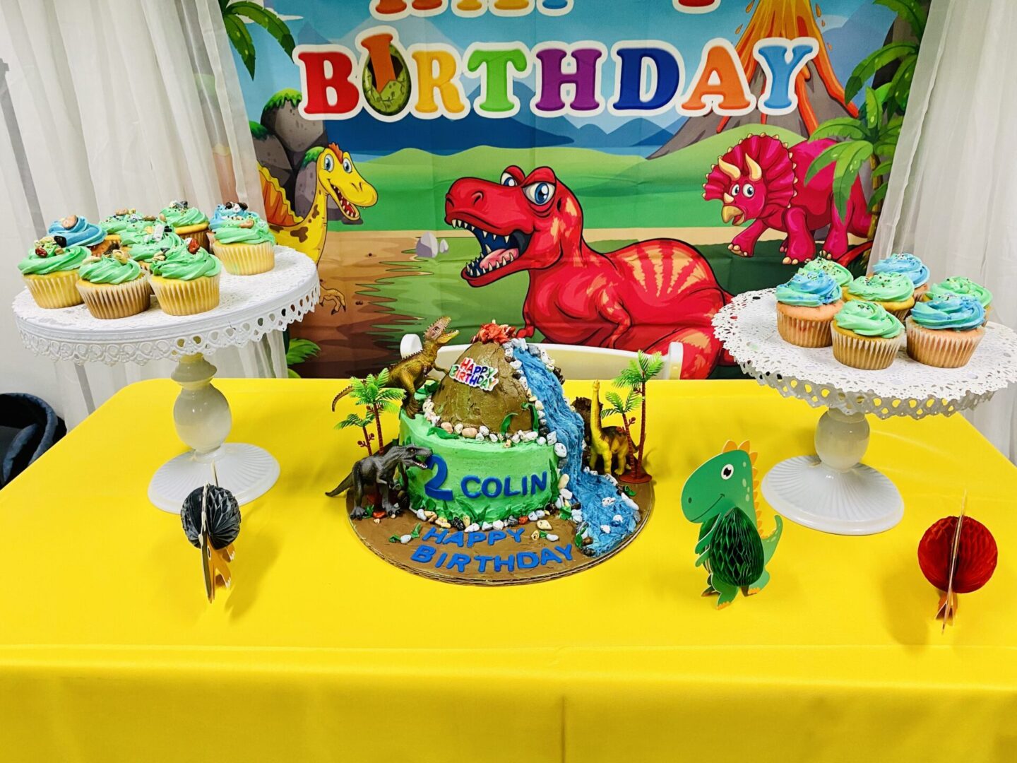 A birthday cake with dinosaur decorations on it.