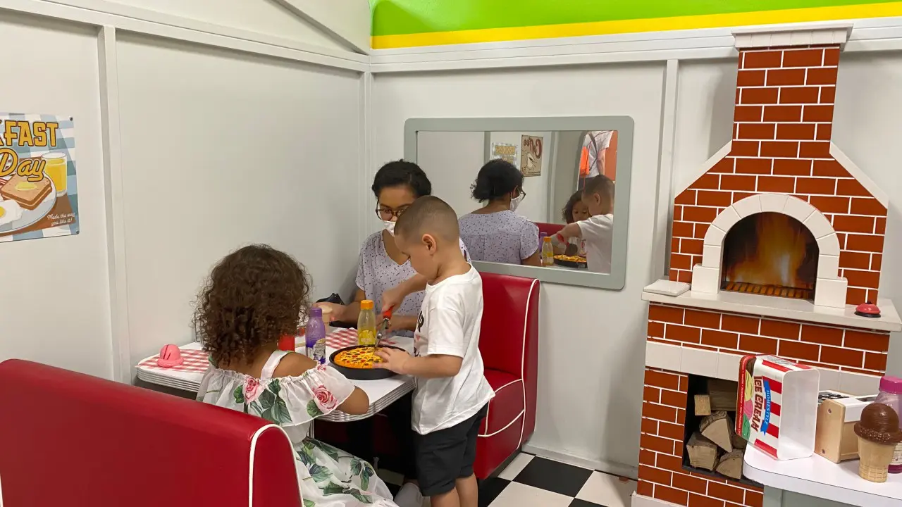 A family sitting at the table in a booth.